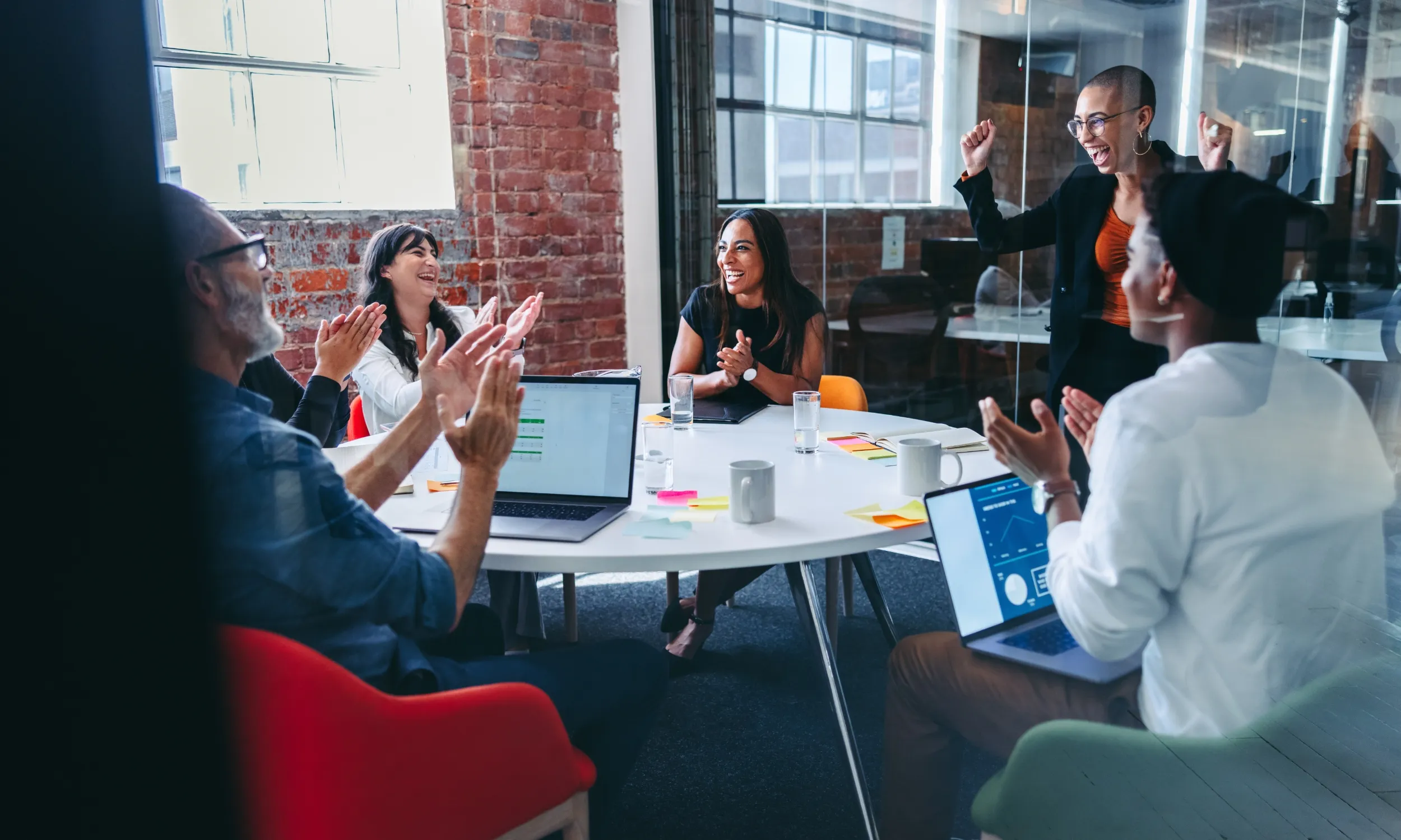 A group of engaged coworkers celebrating in an office.