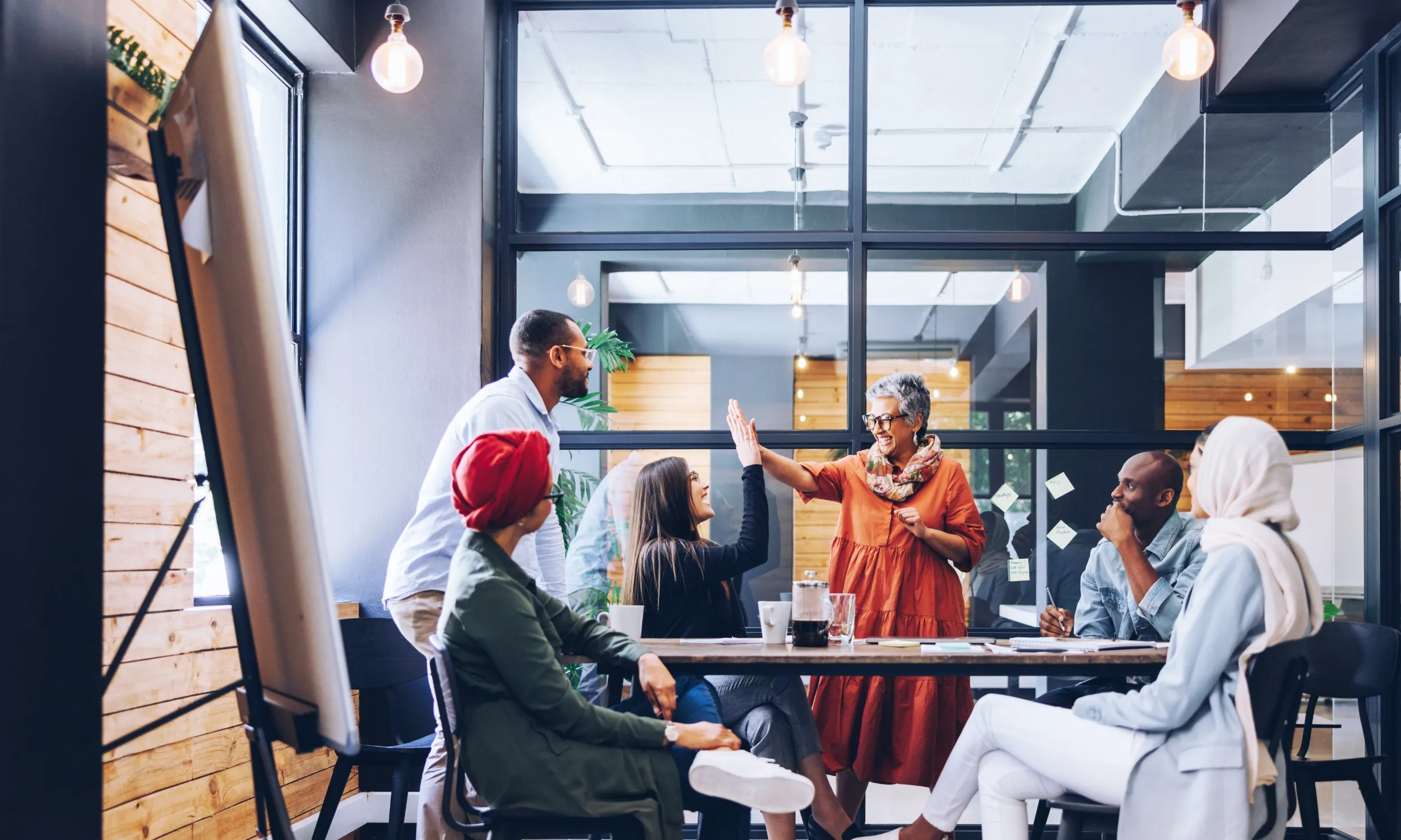A group of engaged coworkers celebrating in an office.