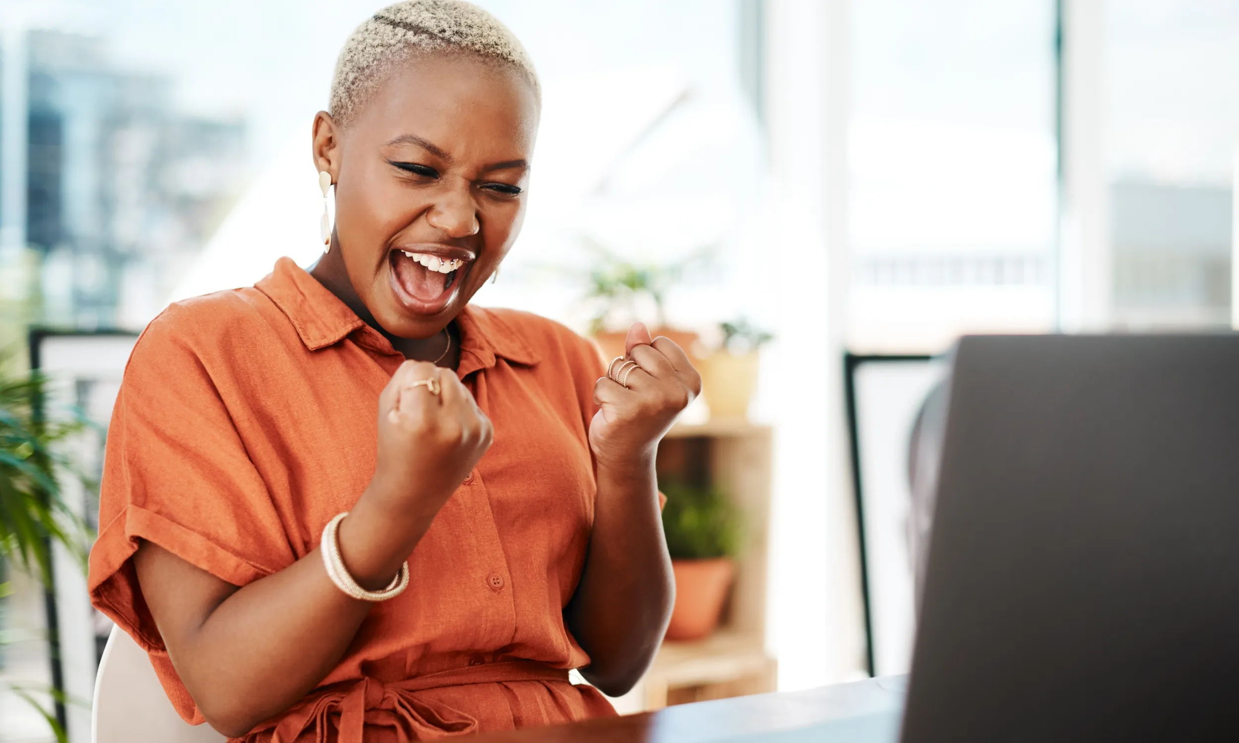 An engaged employee displaying enthusiasm while interacting with a digital employee experience platform.