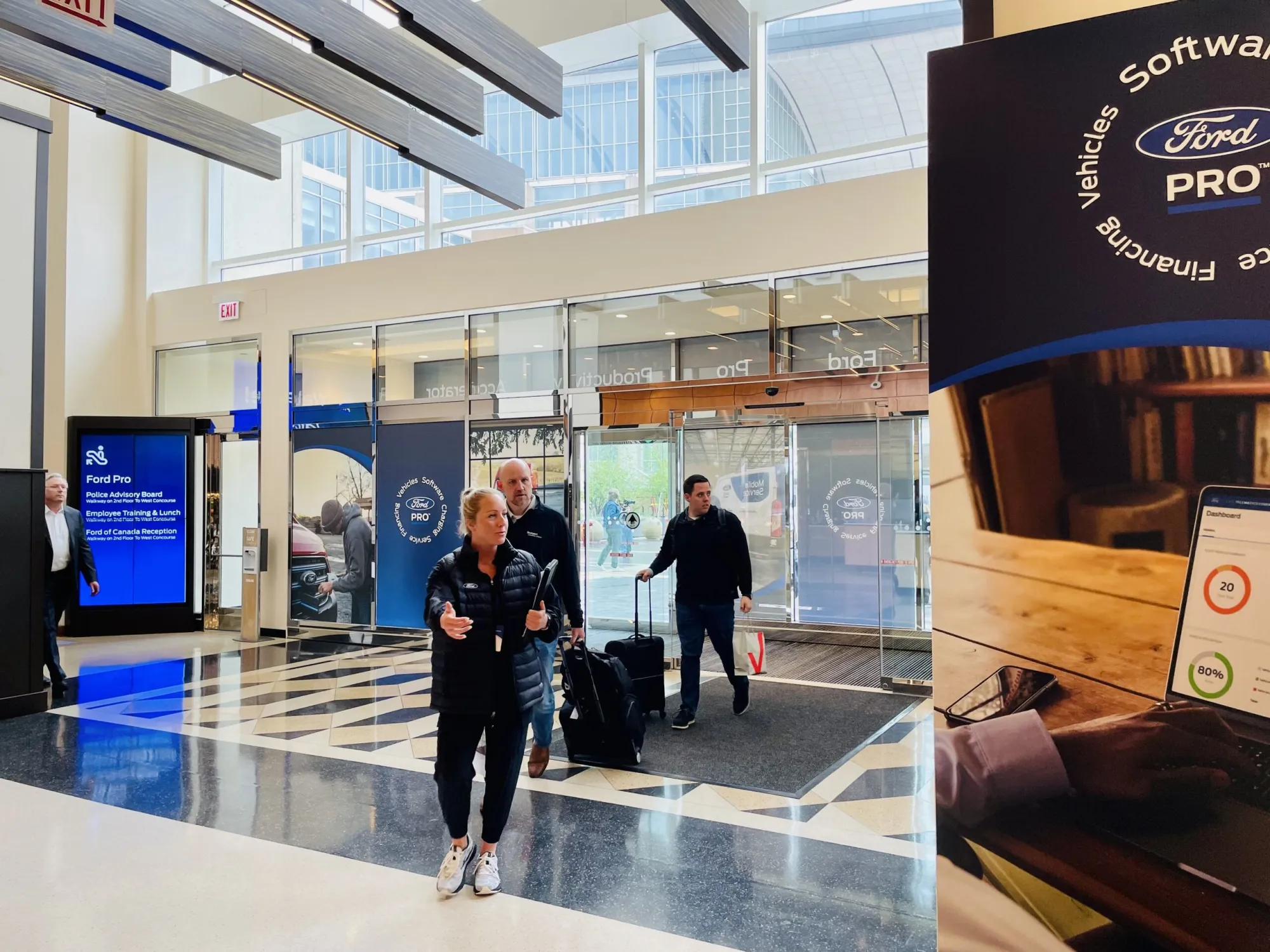 Ford Pro attendees walking through the branded glass entrance toward registration
