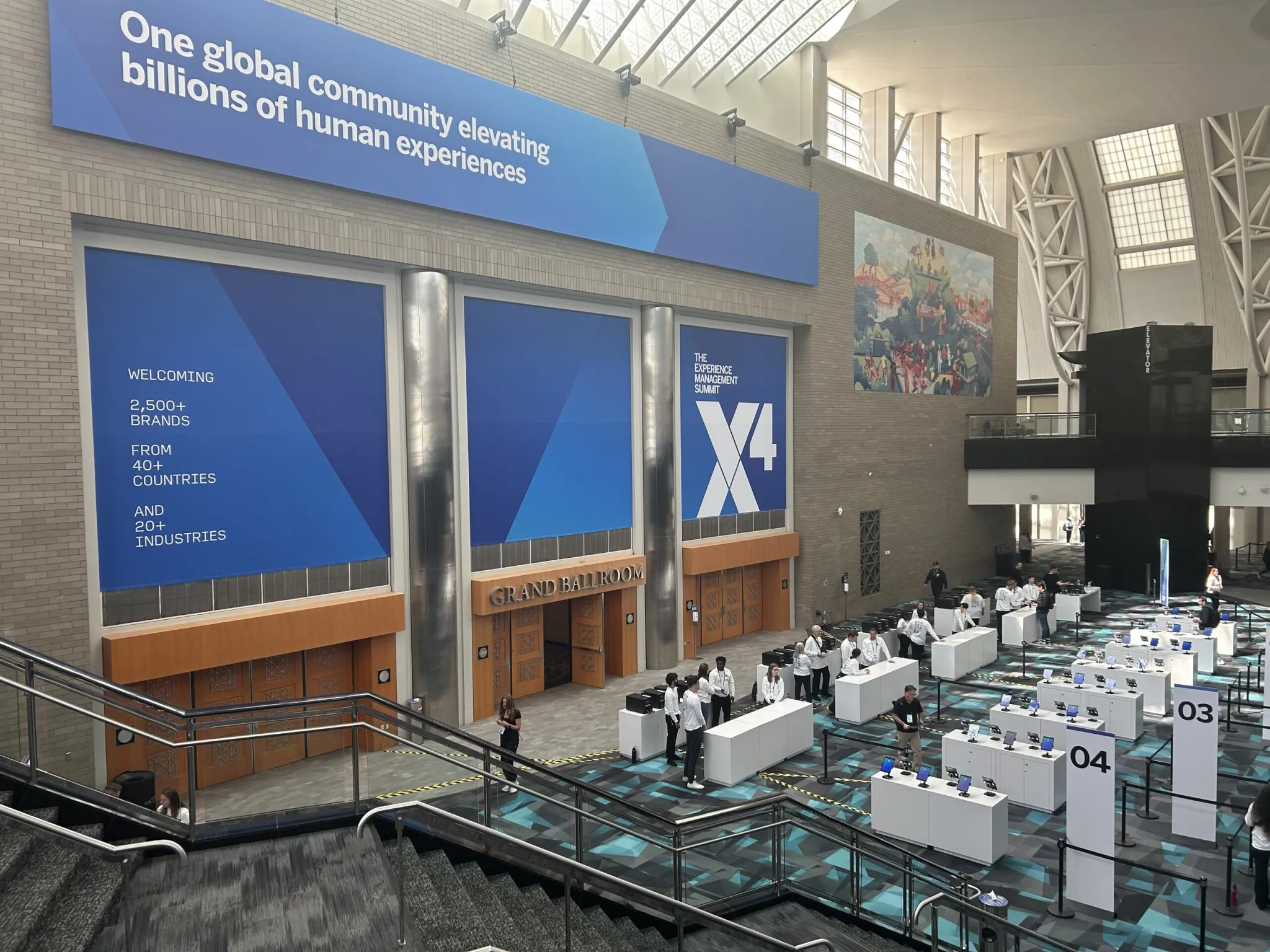 Exterior of the Salt Palace Convention Center with the X4 Experience Management Summit wrap on the cylindrical tower