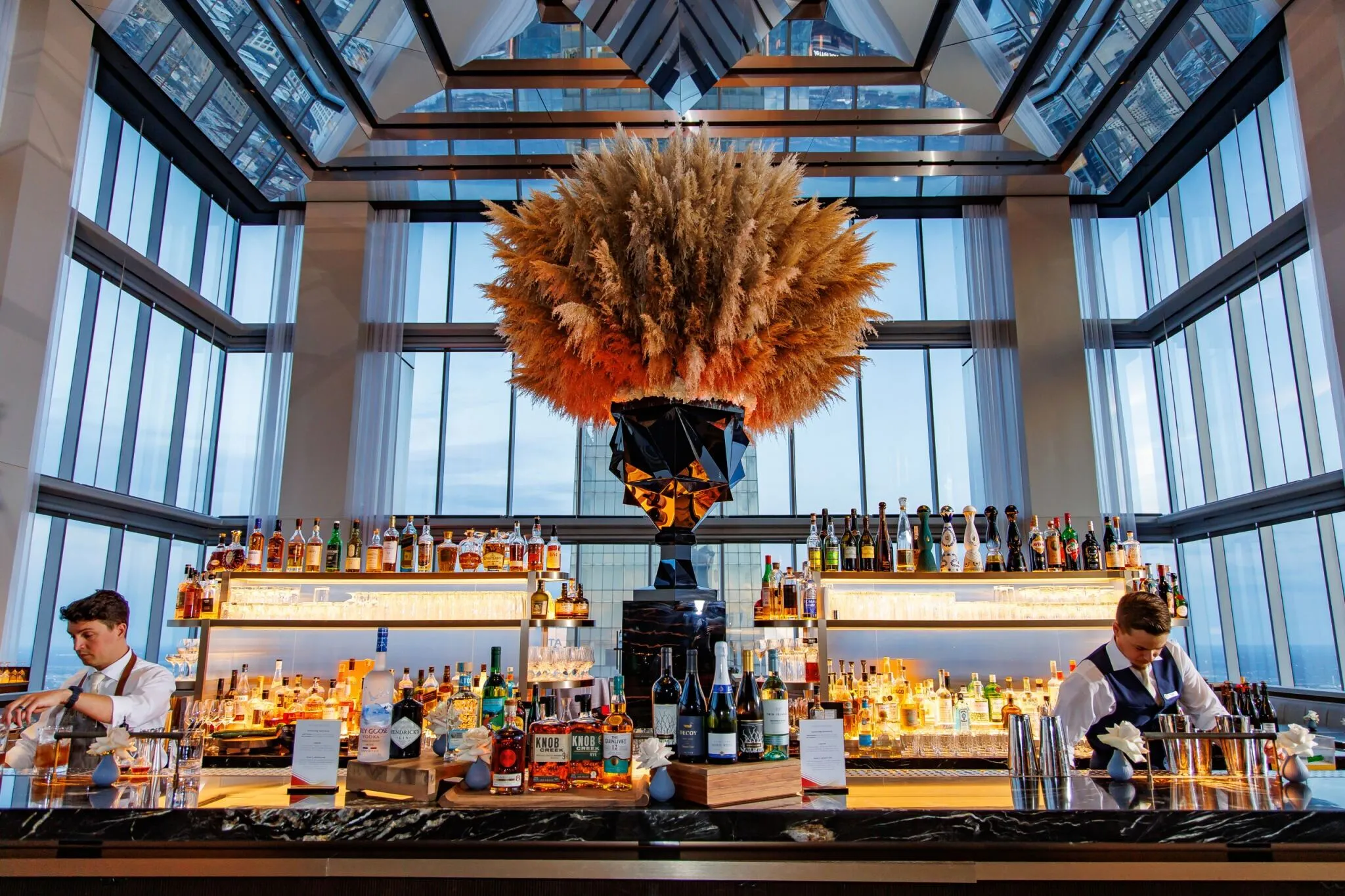 Four Seasons rooftop bar with pampas-grass chandelier and bartenders during the Toyota dealer meeting reception